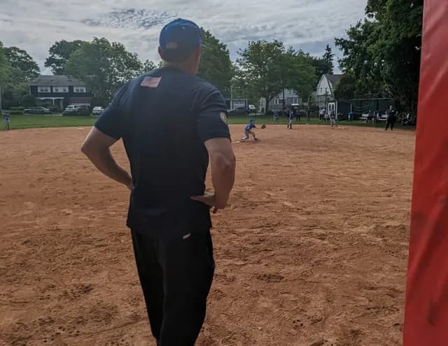 Biagio Maffettone standing watching baseball game